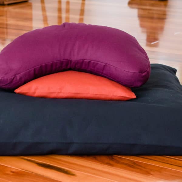 crescent meditation cushion on support cushion and black zabuton meditation cushion
