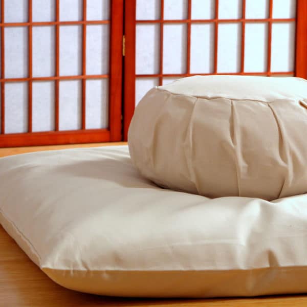 Natural meditation cushion set with zafu and zabuton in meditation space