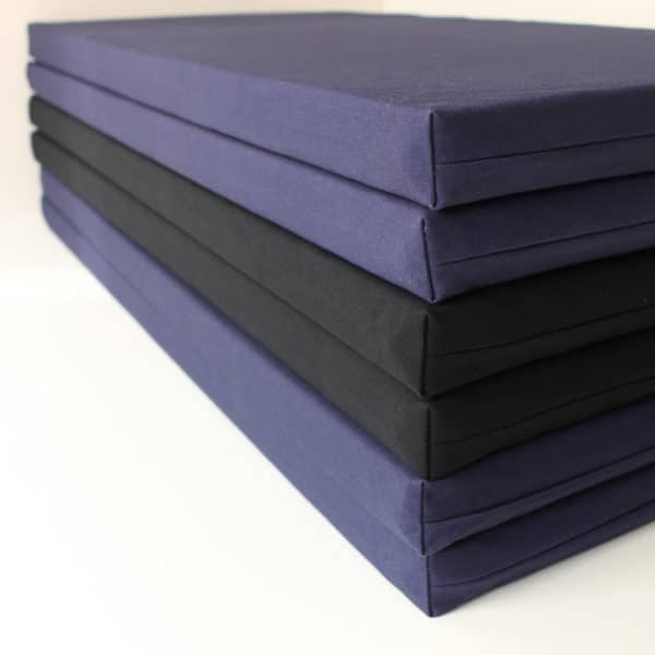 folding zabuton meditation cushions stacked on floor, compact storage