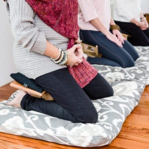 3 meditation benches with people sitting