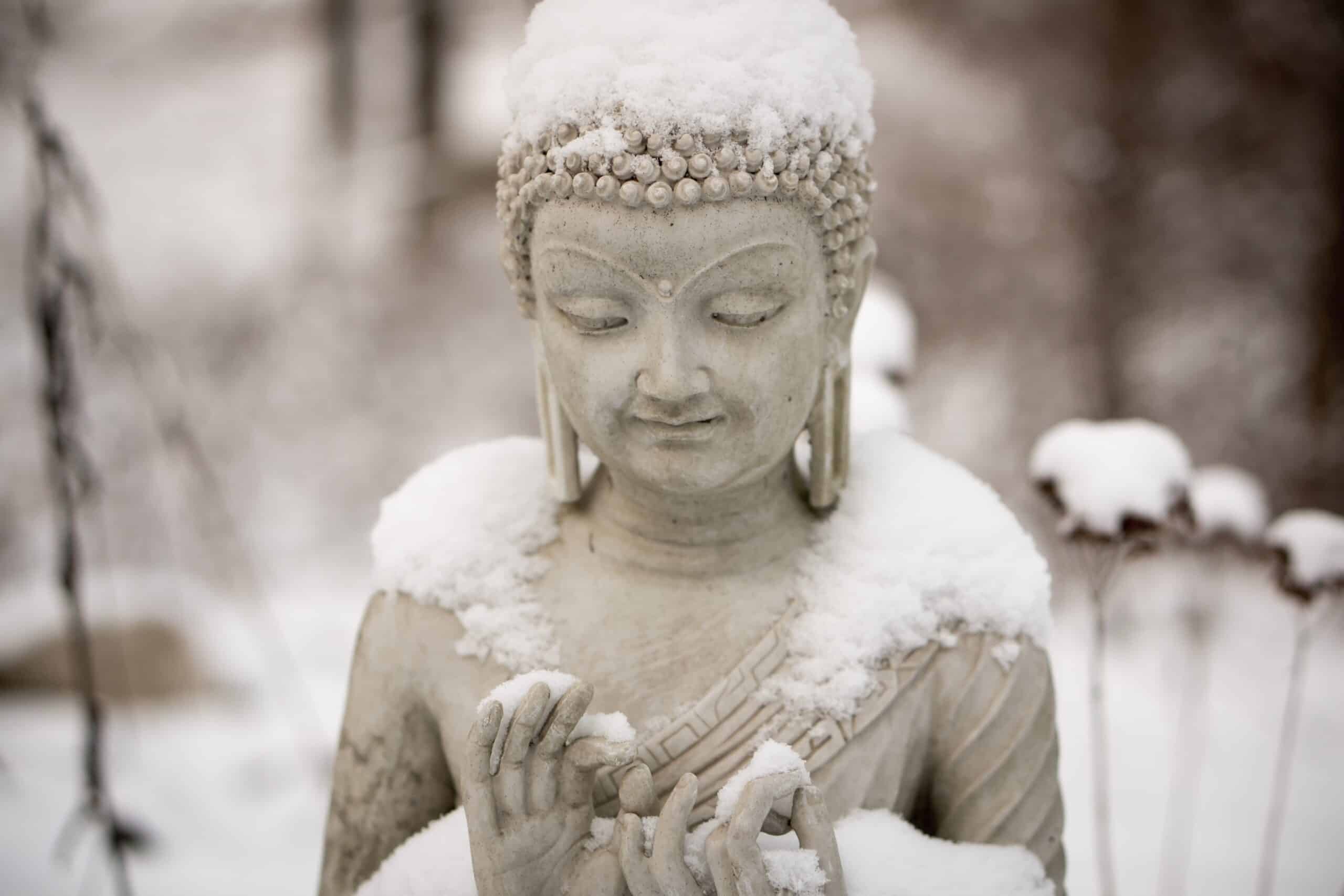 A snow-covered Buddha in winter.